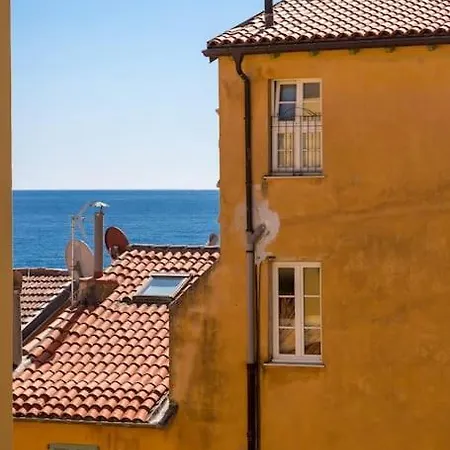 Between The Roofs Of Old Town And The Sea